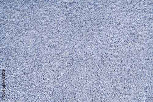 texture background is out of light blue terry fabric, fluffy terrycloth, close-up of textile material, furry  textile, fuzzy, cuddly backdrop, soft surface, fleecy nap,