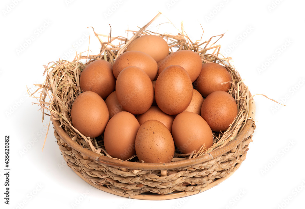 Organic eggs in a straw nest and basket isolated on white background. Organic eggs in a straw nest and basket isolated on white background.