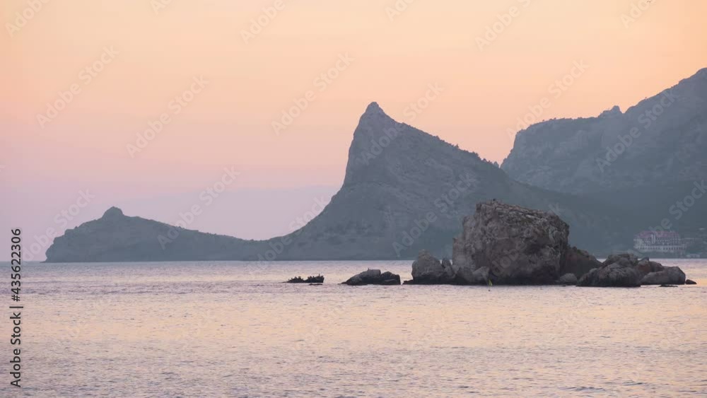 Calm sea and dark rocks at sunset. Dramatic seascape. Calm. 4K UHD Calm sea and dark rocks at sunset. Dramatic seascape. Calm. 4K UHD
