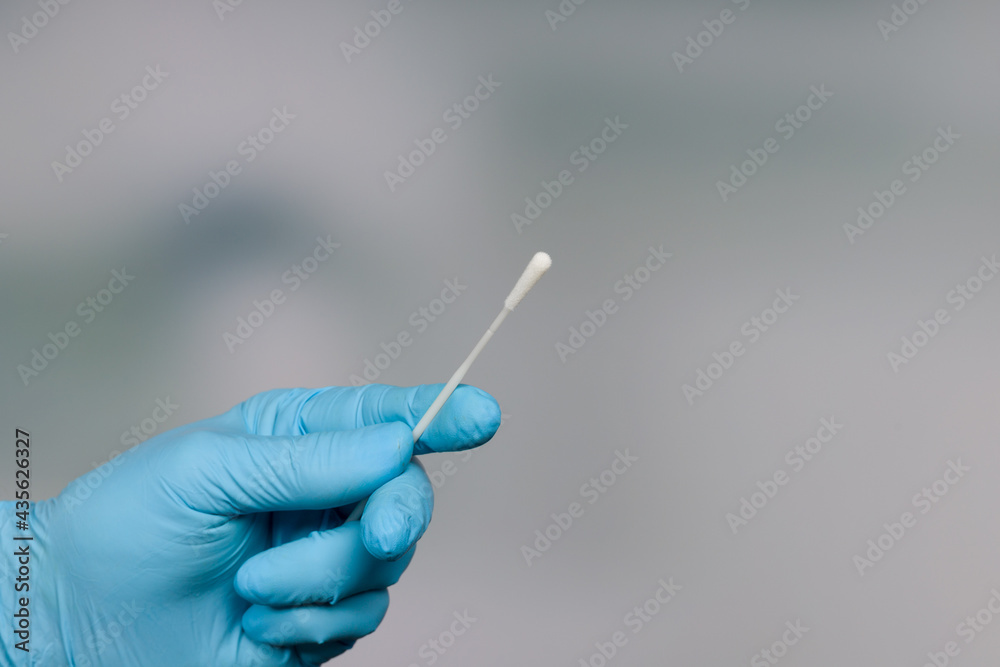 Close up of doctor's hand handling a smear test or swab test Close up of doctor's hand handling a smear test or swab test