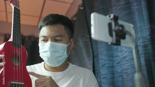 Male vlog influencer performance music show, teaching how to play guitar, streaming to internet online audience listening at home. Man sing a song with smile face. Home entertainer, blogger concept..