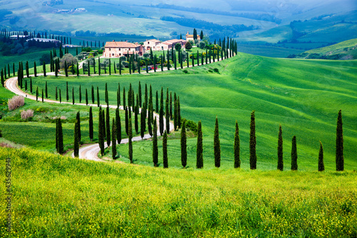 Farmhouse in green summer landscape near Crete Senesi, Tuscany, Italy