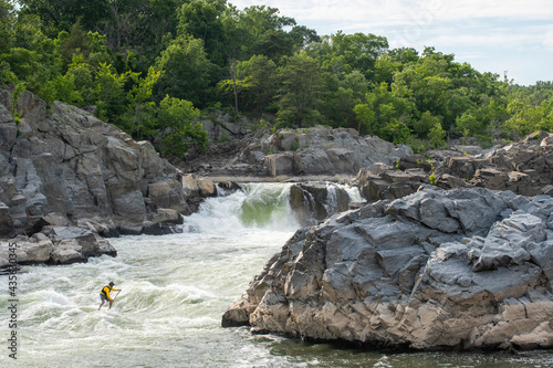 Ian Brown stand up paddle surfs challenging whitewater below Great Falls of the Potomac River, border of Maryland and Virginia photo