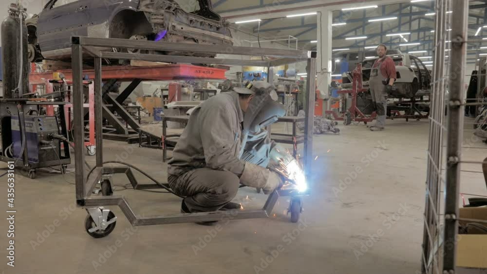 Welder Worker Hand Welds Metal Constructions. Workman In Workshop. Welding Process. A Welder In Helmet Doing His Job Welder Worker Hand Welds Metal Constructions. Workman In Workshop. Welding Process. A Welder In Helmet Doing His Job