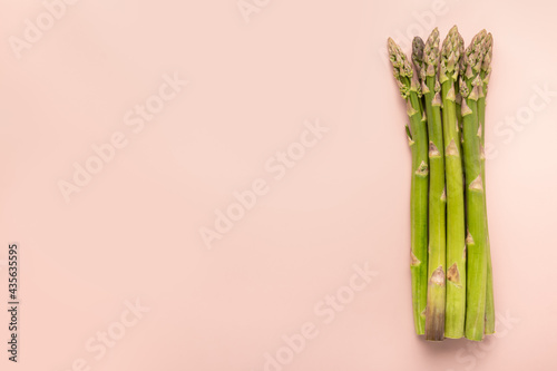 Asparagus is on pink background. Copy space. Horizontal orientation.