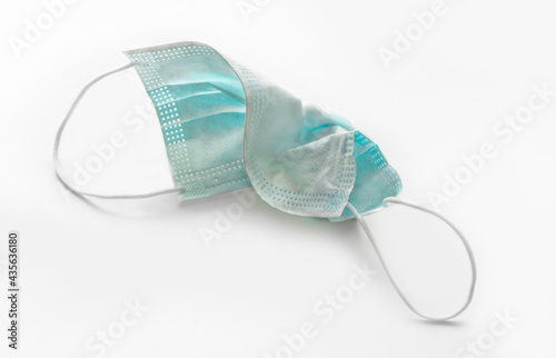 Medical face mask protecting against respiratory diseases transmitted by airborne droplets such as coronavirus and influenza on a white background.