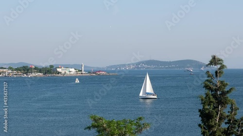 A big sailboat going with sails at The Bay of Kalamis at Istanbul Kadikoy  photo