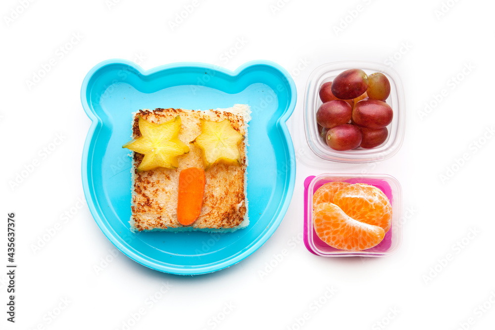 School lunch box snacks for kids over white background. Back to school