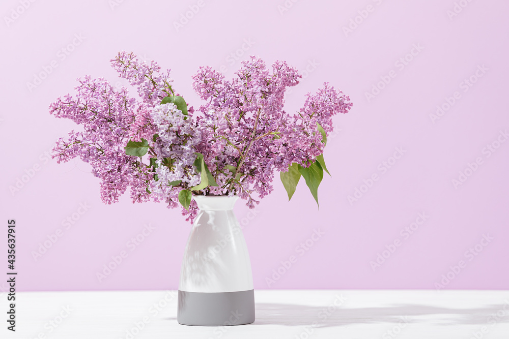 Bouquet of blooming lilacs in vase standing Bouquet of blooming lilacs in vase standing