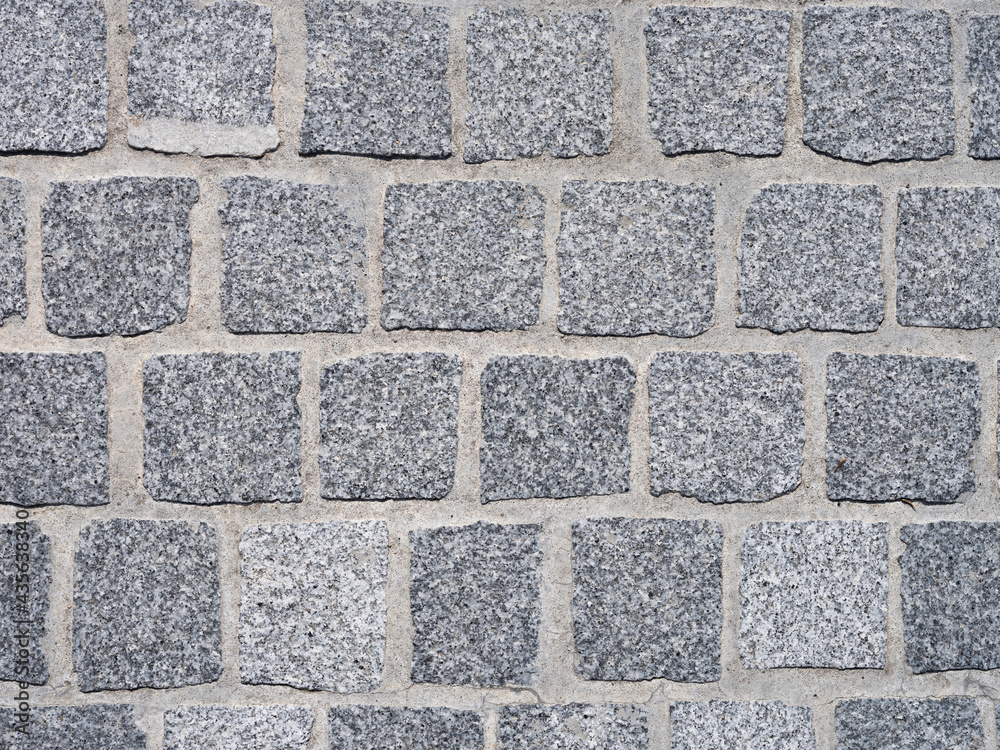 Une matière de pavé de pierre dans une rue Une matière de pavé de pierre dans une rue