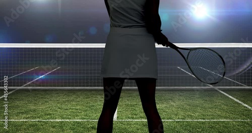 Animation of midsection of female tennis player holding racket over tennis court photo