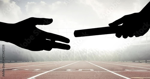 Animation of athlete's hands passing relay baton over racing track in sports stadium photo