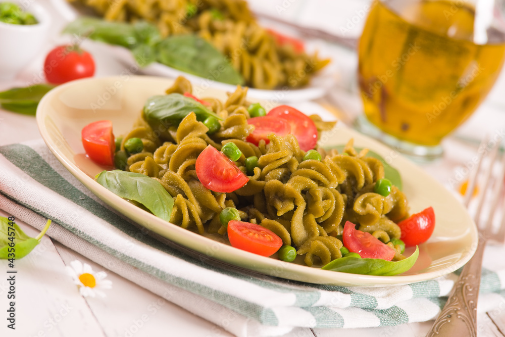 Fusilli pasta with cherry tomatoes and peas. Fusilli pasta with cherry tomatoes and peas.
