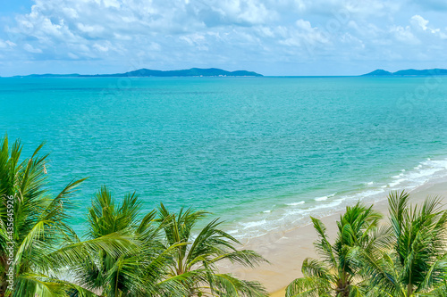 coconut tree over white sandy tropical beach  Sea and Samet island in the background view from top  thailand