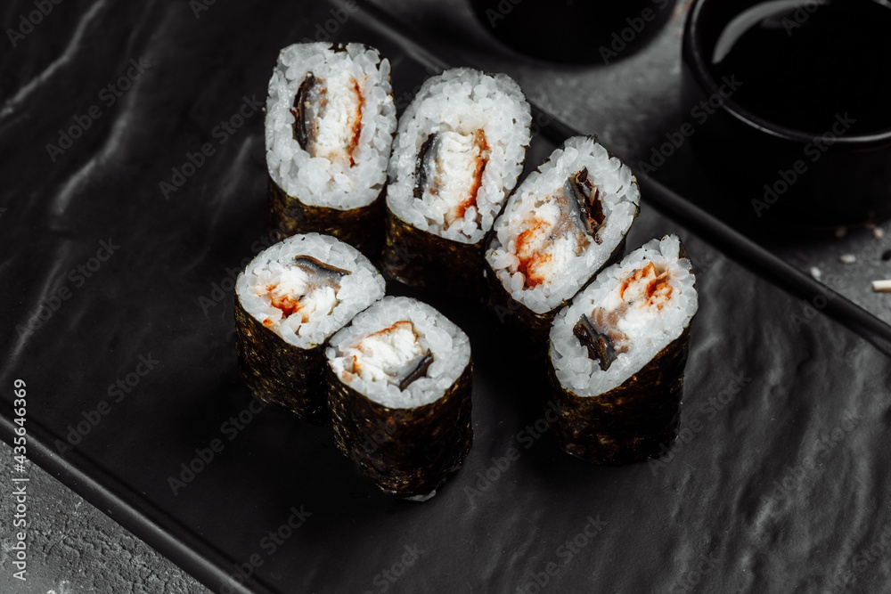 Simple maki with tuna. Sushi on a gray background Simple maki with tuna. Sushi on a gray background