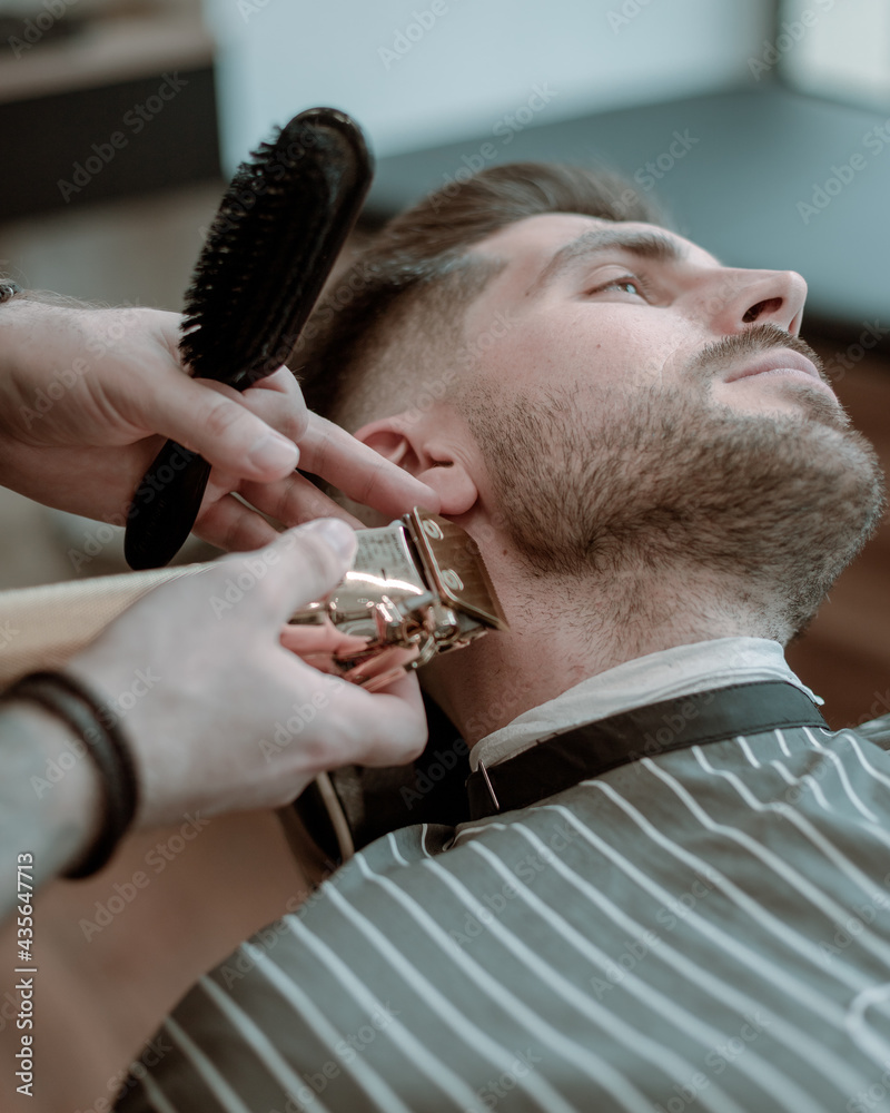 barbershop photography. portrait of a man during hairut