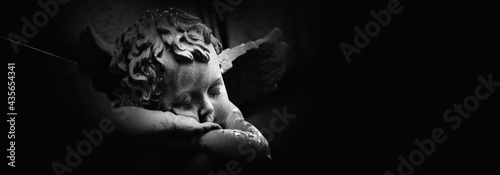 Fotografia, Obraz Ancient statue of  little Dreaming Angel. Copy space for design.
