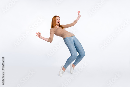 Full length photo of shiny funky ginger lady wear beige shirt smiling dancing isolated white color background