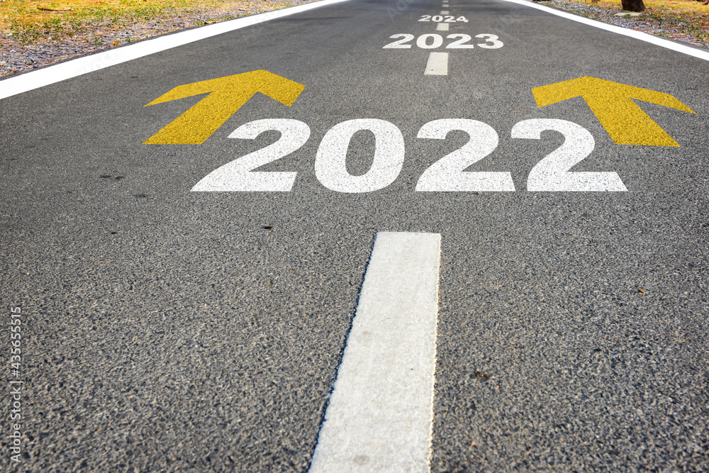Year 2022 to 2024 and yellow arrow sign marking on road surface for giving directions. Business recovery success concept and challenge effort idea