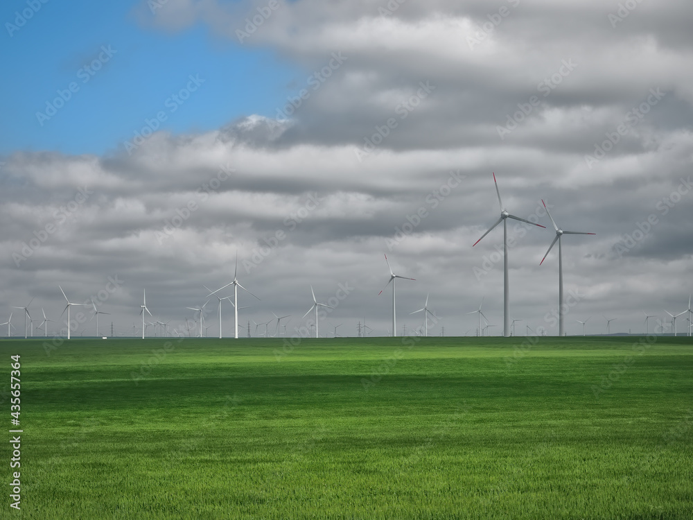 Eolian farm renewable energy in fresh green field against clear blue sky Eolian farm renewable energy in fresh green field against clear blue sky