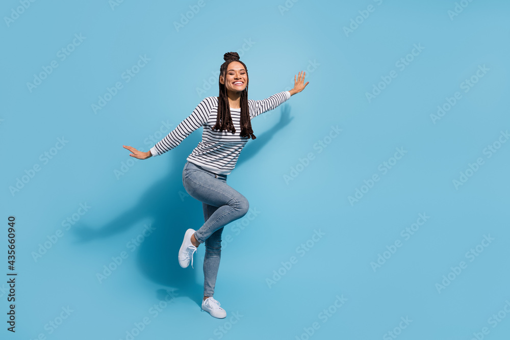Full body profile side photo of young cheerful african girl happy positive smile have fun isolated over blue color background