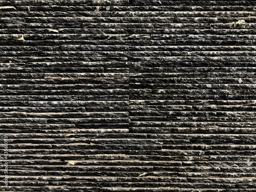 Pattern of dark tone stone wall texture. Rough natural texture background for art work or exterior concept idea. photo