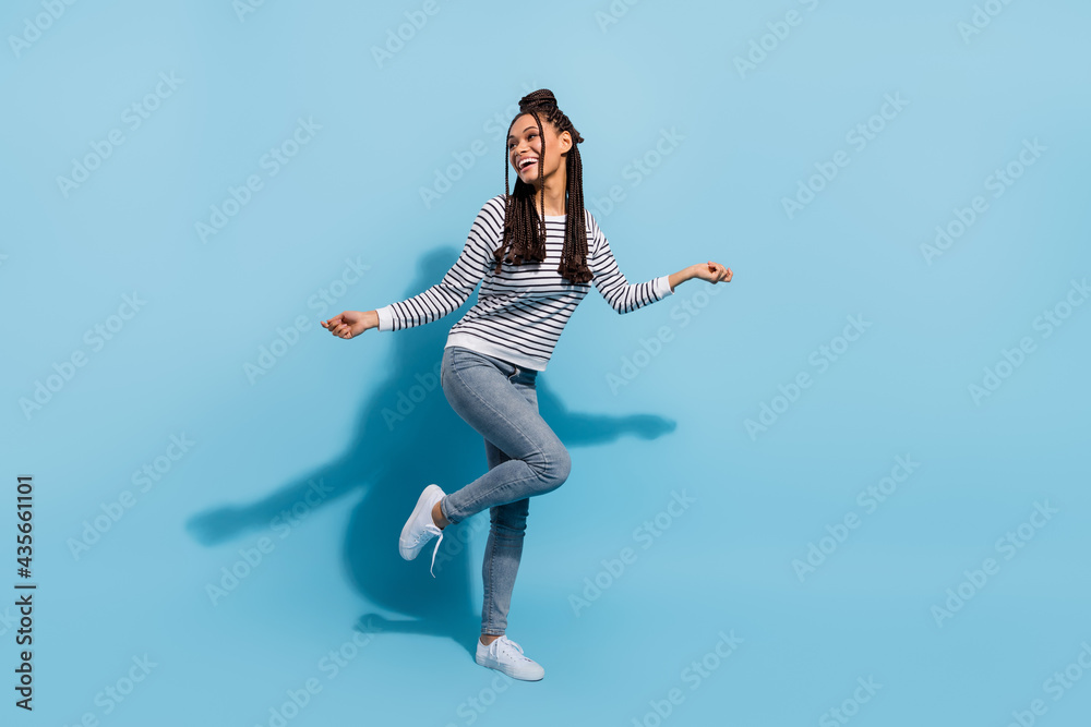 Full body photo of young cheerful black girl happy positive smile dance party isolated over blue color background Full body photo of young cheerful black girl happy positive smile dance party isolated over blue color background
