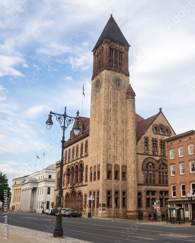 Albany, NY - USA - May 22, 2021: A vertical view of the historic Richardsonian Romanesque Albany City Hall, the seat of government of the city of Albany, New York. Featuring a 202-foot tall tower.