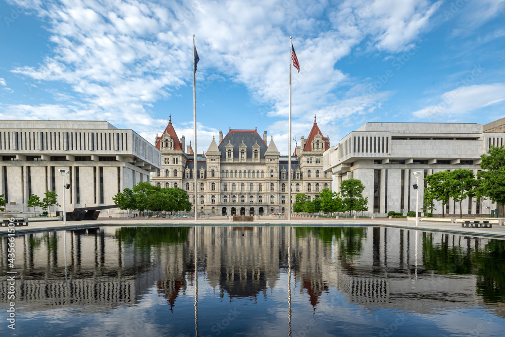 Albany, NY - USA - May 22, 2021: view of the historic New York State Capitol with reflections in the Empire State Plaza's reflecting pools