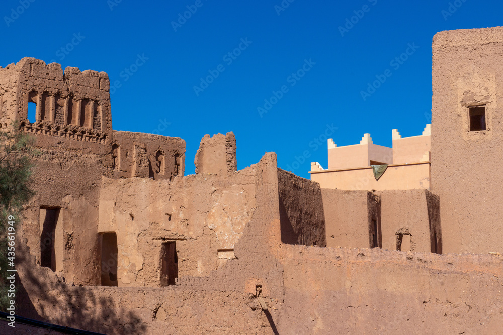 Clay walls of Kasbah of Taourirt against blue sky in Ouarzazate, Morocco