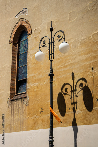 Ornate street lamps in Italy and the shadows they make