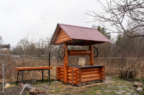 Tablou pe pânză An old wooden well in the courtyard of a country house, a country plot, a Russia