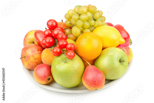 Fruits and vegetables on a platter isolated on a white.