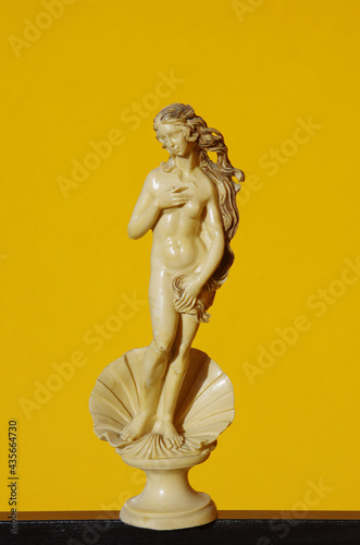 Scale reproduction of Botticelli's Birth of Venus on an orange background
