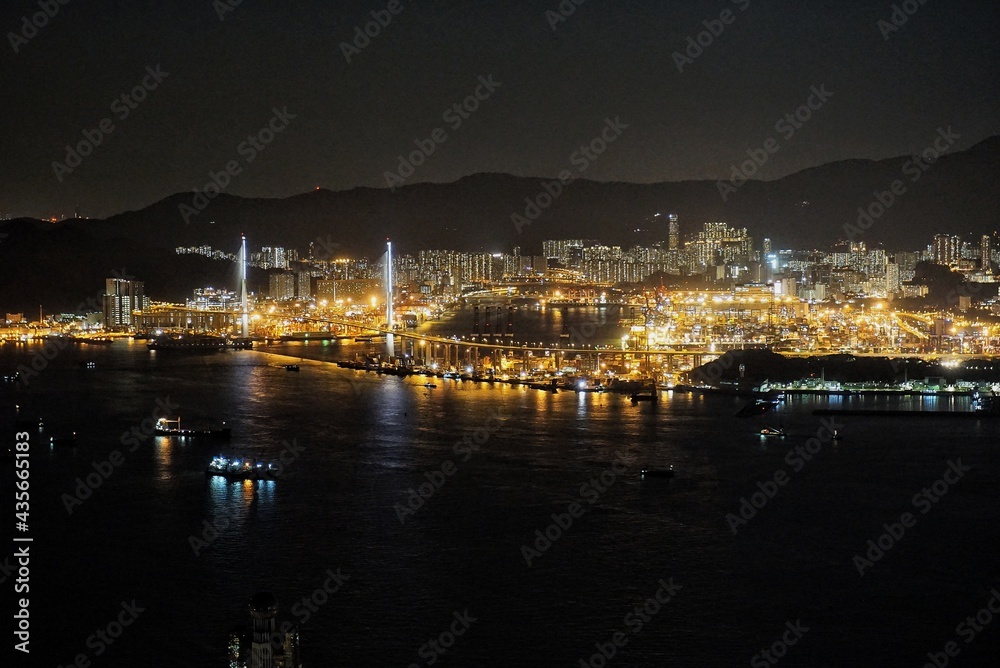 Tsing Yi Hong Kong Stonecutters bridge at night cargo ship loading area