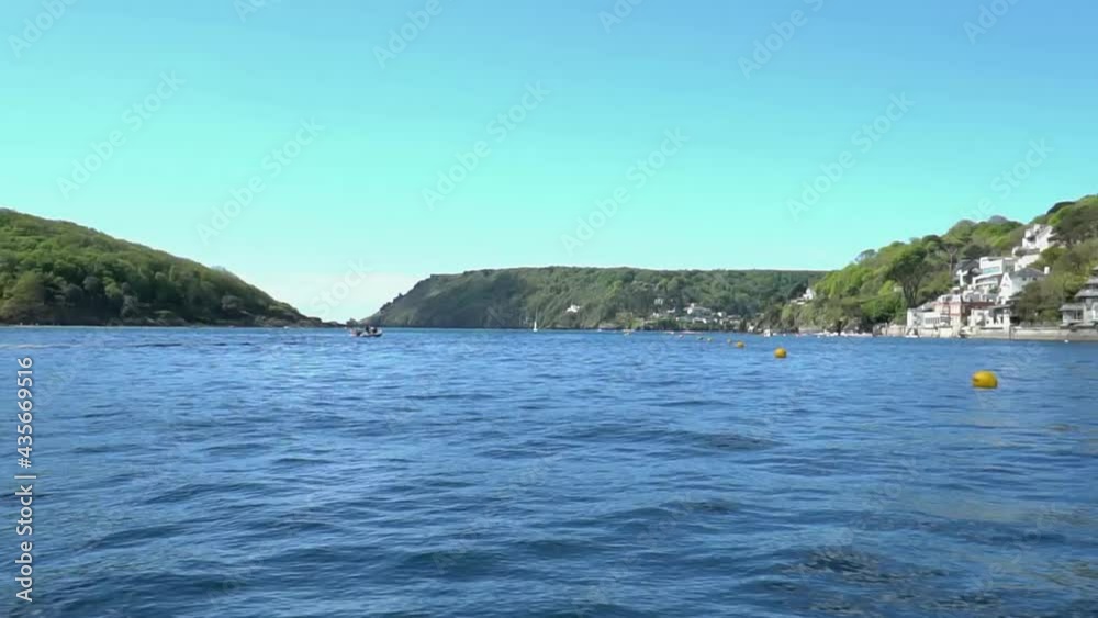 Slow motion pan across the water to inland Salcombe harbour and the Devon coastline. Slow motion pan across the water to inland Salcombe harbour and the Devon coastline.