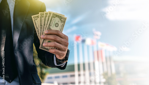 Businessman holding dollar money business investment concept