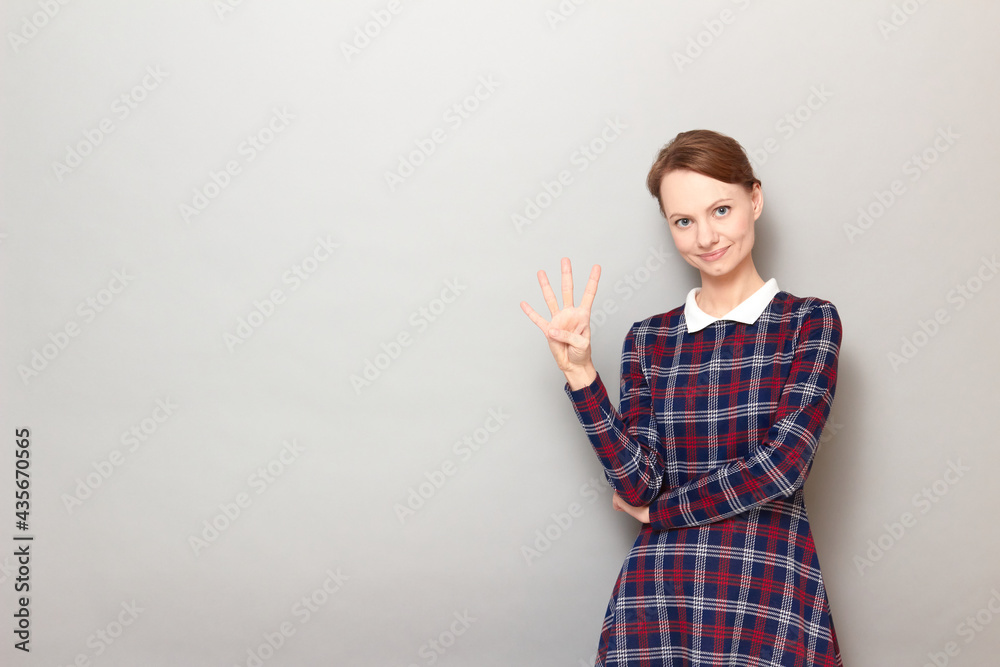 Portrait of happy young woman showing number four with fingers Portrait of happy young woman showing number four with fingers