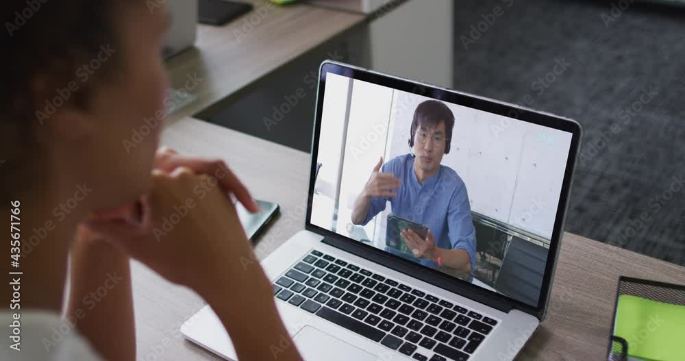 Mid section of african american woman having a video call on laptop with male colleague at office Mid section of african american woman having a video call on laptop with male colleague at office