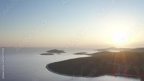 4K peaceful sunrise drone footage over Croatian coast in early morning. Little uninhabited islands seen off-shore. Nature, exploration, wondrous planet Earth concept.