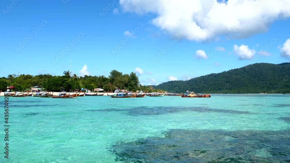 View from Boat on Tropical Island with Boats near Sea Beach with Green Palm Trees. Vacation and Holidays in Thailand. Clear Crystal Sea Water with Coral Reef. Travel Tourist Tour. 4k View from Boat on Tropical Island with Boats near Sea Beach with Green Palm Trees. Vacation and Holidays in Thailand. Clear Crystal Sea Water with Coral Reef. Travel Tourist Tour. 4k
