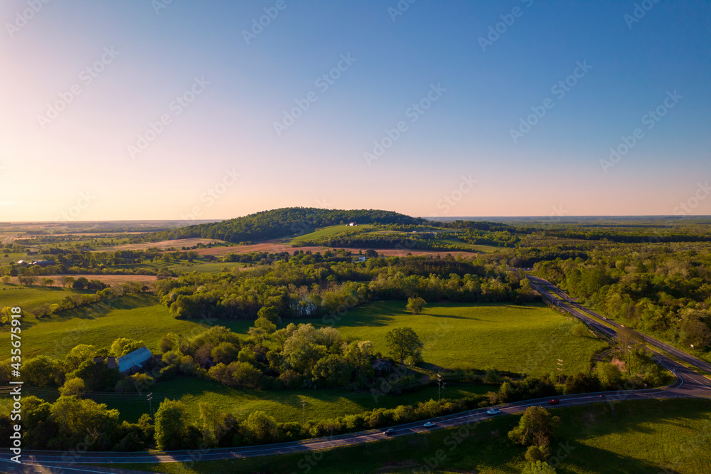 Little house on a hill on the countryside with clear sky at sunrise 