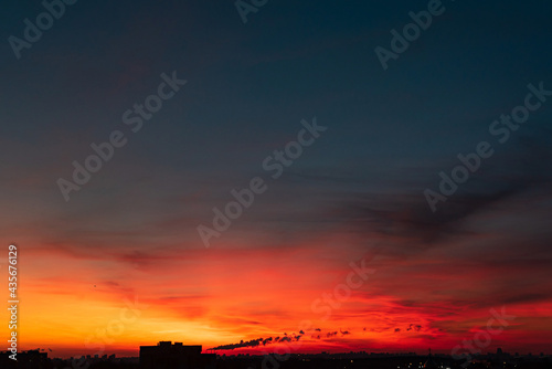 orange sunset over big city © Maksim Shebeko