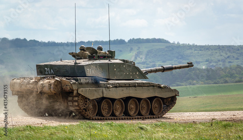 close-up of a british army Challenger 2 ii FV4034 main battle tank kicking up dirt in action on a military exercise