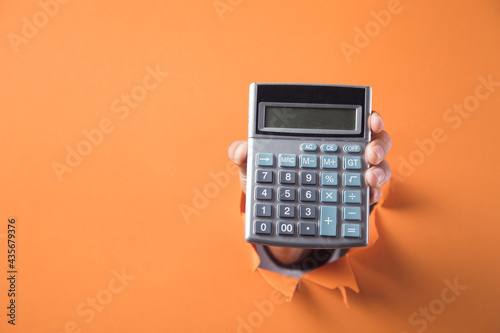 Hand holds calculator photo