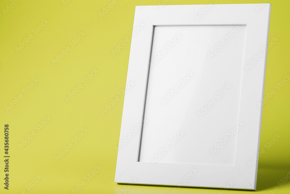White photo frame on yellow background with free space. White photo frame on yellow background with free space.