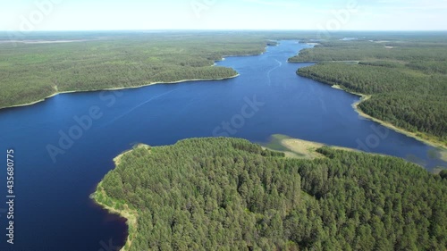 Flight over the taiga forest lake