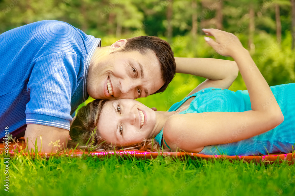 Fototapeta premium Happy beautiful couple on nature and pregnant in the park