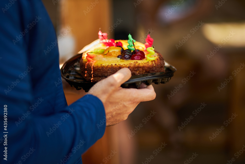male hands close-up with a cake in their hands. 