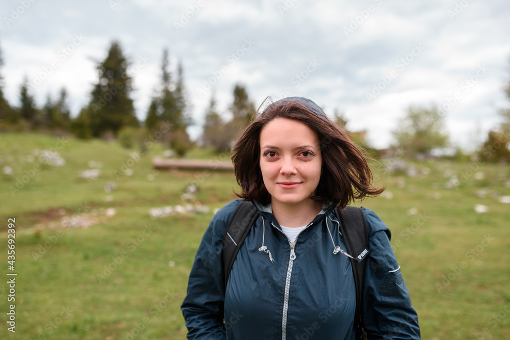 portrait of a woman hiking with a backpack on her back. High quality photo